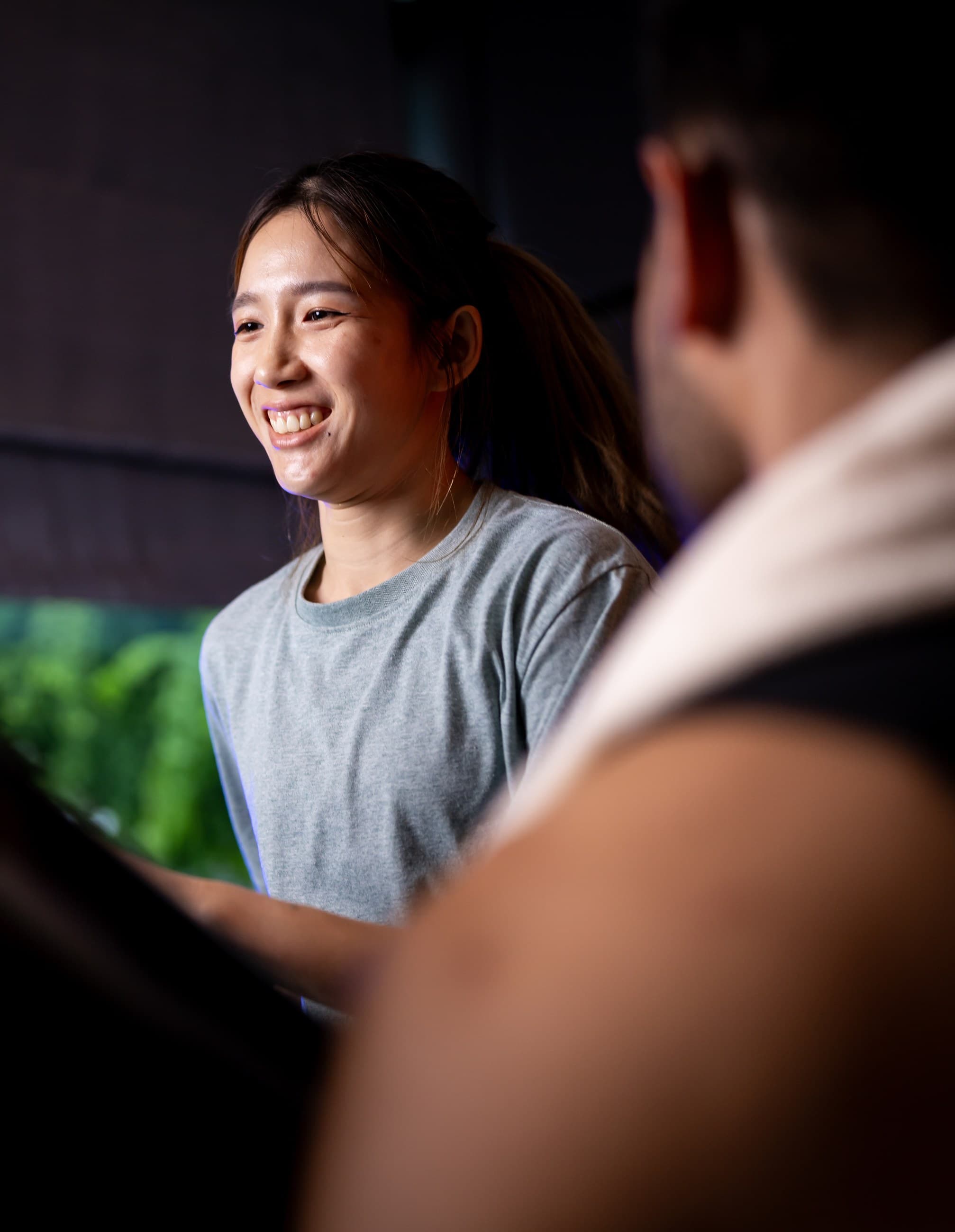 Fitquarters team member smiling with a client in the gym
